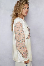 Cream-colored cream oversized star patch thermal top with long sleeve length floral sleeves and decorative shoulder seam beads