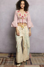 Pink embroidered crop top with flared ruffle sleeves and red tassel tie at neckline from pol floral collection