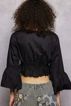 Black floral embroidered cropped blouse with ruffled sleeves and gathered waistband for stylish casual wear