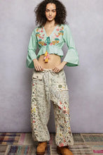 Light green floral embroidered cropped blouse with colorful embroidery and ruffled sleeves by POL