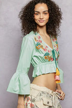 Mint green floral embroidered cropped blouse with colorful embroidery and bell sleeves perfect for stylish wear