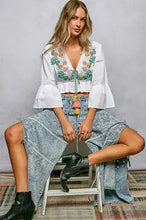 White pol floral embroidered cropped blouse with bell sleeves and a colorful tassel belt for women