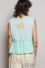 Back view of mint green sleeveless pol floral patch top with raw edge detail and ruffled hem