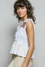White sleeveless top with pol floral patch colorful embroidered floral detail raw edge ruffled hem