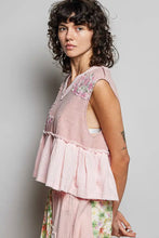 A soft pink sleeveless top with floral patch ruffled tiered hem and raw edge detail perfect for summer wear