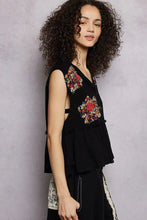 Black sleeveless top with pol floral patch embroidery and raw edge detail featuring red gold and green floral patch design