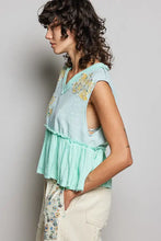 Mint green sleeveless top with pol floral patch embroidery ruffled hem and raw edge detail for stylish wear