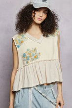Beige floral patch ruffled sleeveless top with raw edge detail and embroidered hem for casual wear
