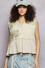 Beige floral patch ruffled sleeveless top with raw edge detail and floral embroidery on shoulders and ruffled hem