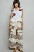 White sleeveless top with pol floral patch embroidery at shoulders and ruffled hemline with raw edge detail