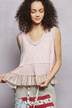 A soft pink pol floral textured tank sleeveless top with knit fabric and delicate ruffle hem trim at the bottom