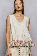A cream-colored pol floral print v neck textured tank with lace detailing and a colorful floral ruffle hem trim