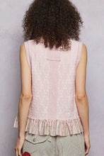 A soft pink pol floral textured tank with sleeveless design and delicate ruffle hem featuring floral embroidery