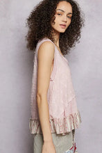 A soft pink pol floral textured tank featuring a sleeveless design and a layered ruffle hem