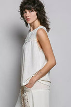 A soft off-white sleeveless top with double gauze patch fabric and delicate lace detailing around the neckline