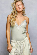 Soft sage green ribbed cami with delicate white pol lace trim along neckline and straps in a knit fabric