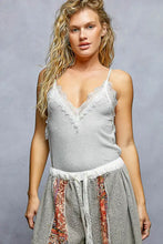 A light gray pol lace detail v-neck ribbed cami with delicate white lace trim along the neckline and straps