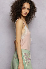 A soft pink pol lace cami tank with delicate white lace trim and a v-neck ribbed neckline and armholes