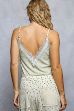 A soft sage green pol lace ribbed cami with delicate white lace trim along the neckline and back