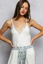 White pol lace neck ribbed cami with lace trim and spaghetti straps in a delicate ribbed fabric