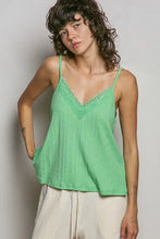 A light green ribbed cotton textured knit cami with delicate lace trim along the v-neckline
