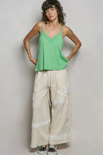 A light green textured knit cami with ribbed cotton fabric and delicate lace trim at the neckline