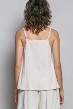 Off-white textured knit cami with lace detail and thin adjustable spaghetti straps in a ribbed knit fabric