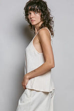 Off-white textured knit cami with lace detail v-neck, spaghetti straps, ribbed texture, and a flared hem