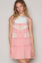 Pink tiered denim overall dress with lace patchwork lace accents silver buttons and adjustable straps