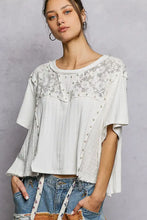White short sleeve shirt with lace detailing pearl stud embellishments and a round neck design