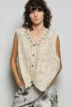 Cream-colored pol lace trim embroidered floral v-neck crochet vest with intricate lace trim and decorative buttons