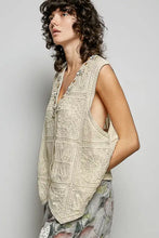 Beige crochet sleeveless top with intricate floral patterns and delicate beaded pol lace trim along the neckline