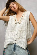 White lace sleeveless vest with pol lace trim butterfly motifs and beaded embellishments along the neckline