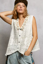 White sleeveless vest featuring intricate butterfly embroidery and beaded neckline with pol lace trim detailing