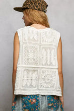 White crochet patchwork sleeveless vest featuring pol lace trim embroidered floral design and v neck detail