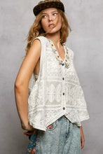 White lace sleeveless vest with floral embroidery black buttons featuring pol lace trim detailing