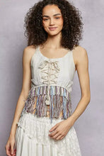 White lace pol lace fringe hem tank featuring corset-style front lacing and colorful fringe hem detail