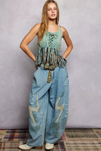A light blue denim fringe hem tank with lace-up detail distressed patches and embroidered lightning bolts