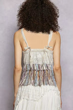 A light gray pol lace fringe hem tank with thin shoulder straps tied into bows and colorful fringe hem detail