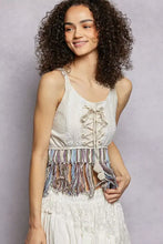 White pol lace fringe hem tank with colorful fringe detail at the waist and lace-up front detail