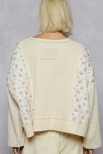 Cream-colored quilted knit cropped top with ribbed texture and floral pastel patchwork sleeves for best fit comfort