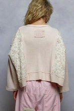 Off-white waffle-knit cropped sweater with quilted knit floral pattern sleeves raw edge and back patch pocket visible