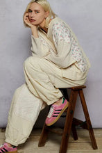 Pink adidas sneakers with black stripes and gum sole paired with a best fit quilted knit thermal floral cropped top