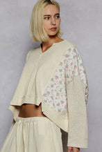 Cream-colored quilted knit cropped sweater with ribbed texture and floral patchwork sleeves for best fit style