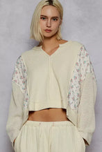 Cream-colored cropped sweater with quilted knit ribbed body and floral-patterned sleeves for best fit and style