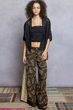 POL Open Front Crochet Cardigan with intricate floral embroidery on leopard-print pants
