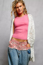 Pink openwork lightweight sweater cardigan over sleeveless crop top