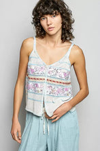 A light blue and white knitted sleeveless pol printed contrast cami with floral patterns and blanket stitch trim detail