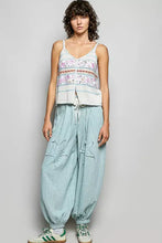 Light blue loose-fitting cotton harem pants with distressed star patches and drawstring cuffs featuring pol printed contrast blanket stitch