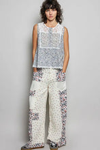 White floral patchwork wide-leg pants with lace trim paired with a pol printed woven lace back sleeveless top
